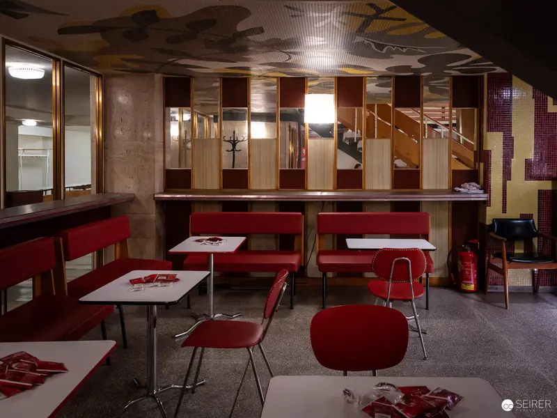 Mid-Century Modern Café Interior with Red Seating and Geometric Design