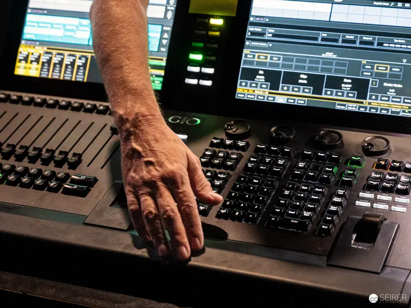 Sound Engineer's Hand on Professional Audio Mixing Console