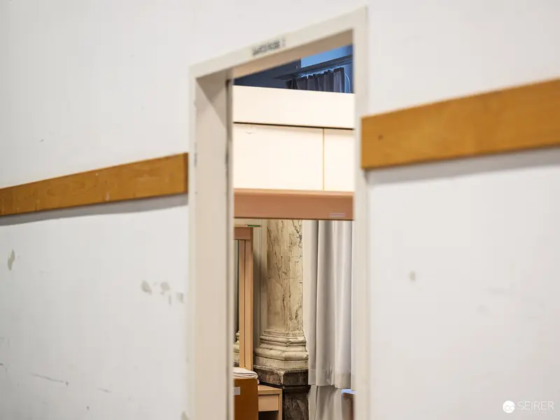 Architectural Framing: Doorway Revealing Partial Classical Column in Interior Space