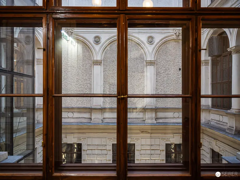 Architectural Interior View Through Wooden-Framed Window at Historic Building