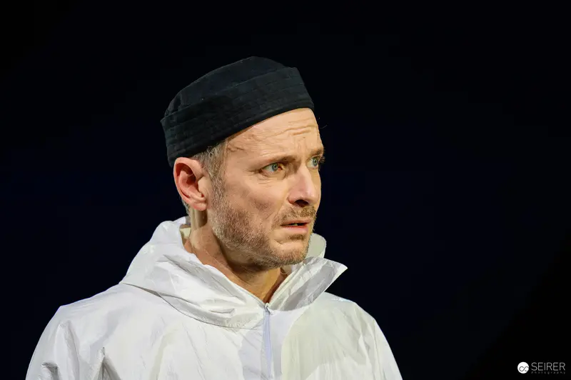 Intense Actor in White during Theatrical Rehearsal of Wedekind's Lulu