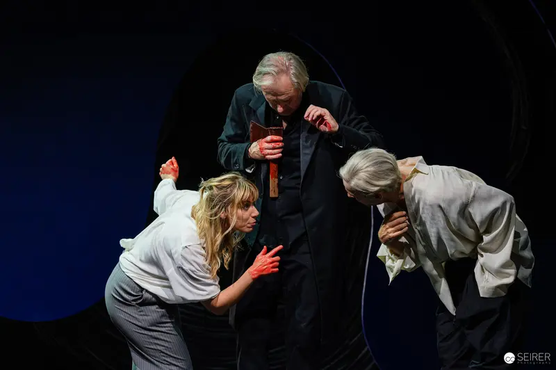 Dramatic Staging of Lulu with Performers in Tense Theatrical Interaction