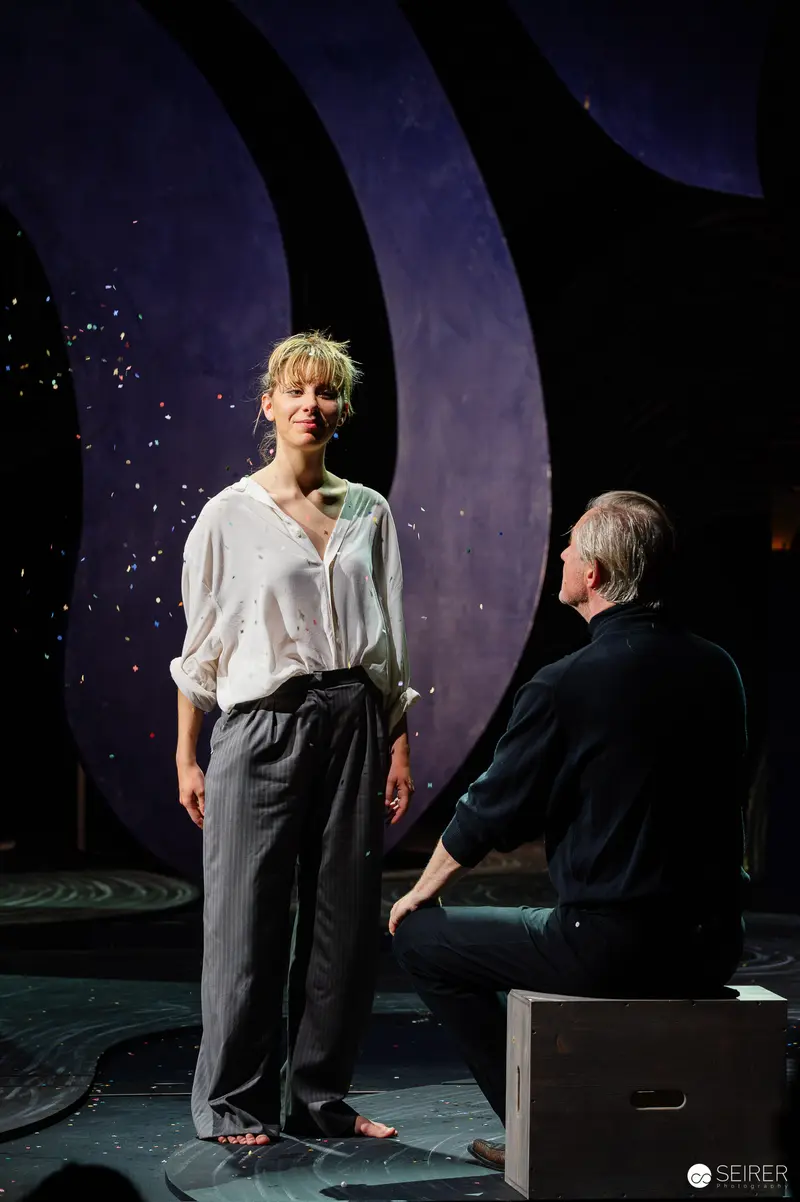 Lulu Staging: Dramatic Encounter on Starlit Theatrical Set