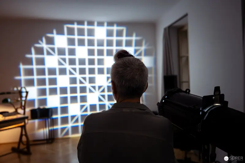 Gridded Light Projection with Photographer Behind Camera in Studio Setting