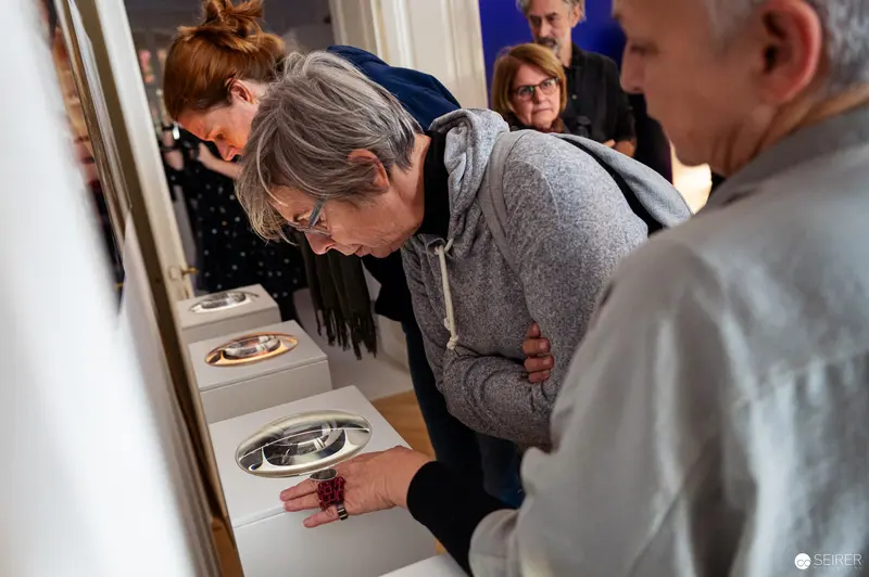 Scholars Examining Archival Artifacts with Concentrated Scrutiny