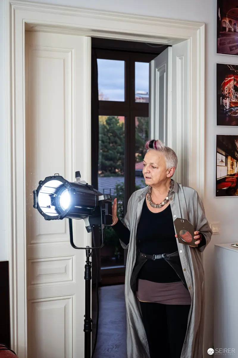 Professional Photographer Adjusting Studio Lighting Near Doorway