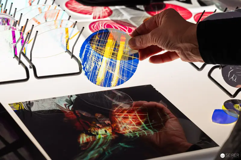 Digital Artist Manipulating Colorful Graphic Design Elements on Workstation
