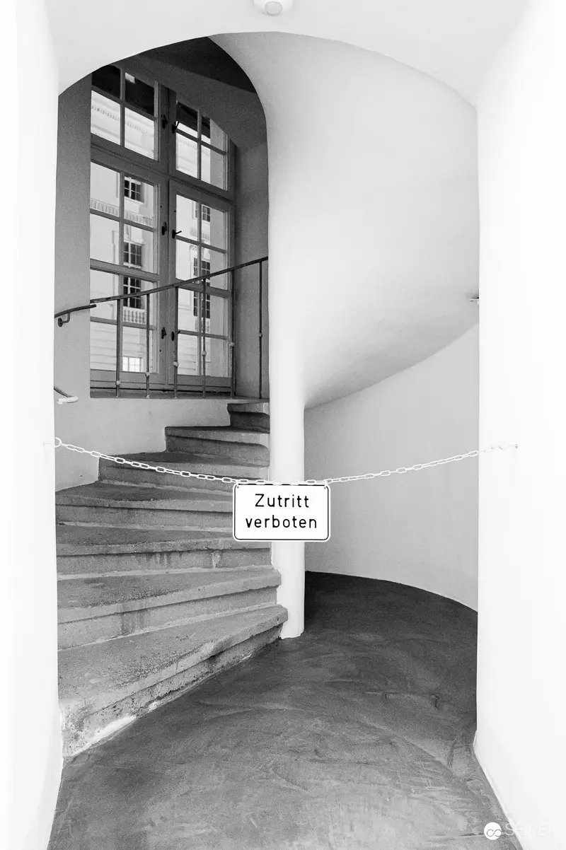 Restricted Stairwell with Arched Window and Entrance Sign