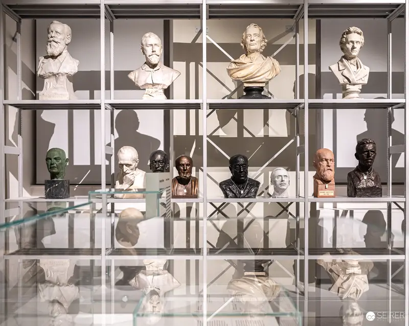 Sculptural Portrait Collection Displayed in Systematic Modernist Grid Shelving