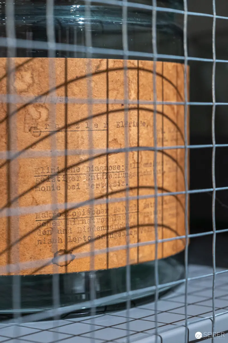 Wire Mesh Framing Cylindrical Object with Typographic Overlay