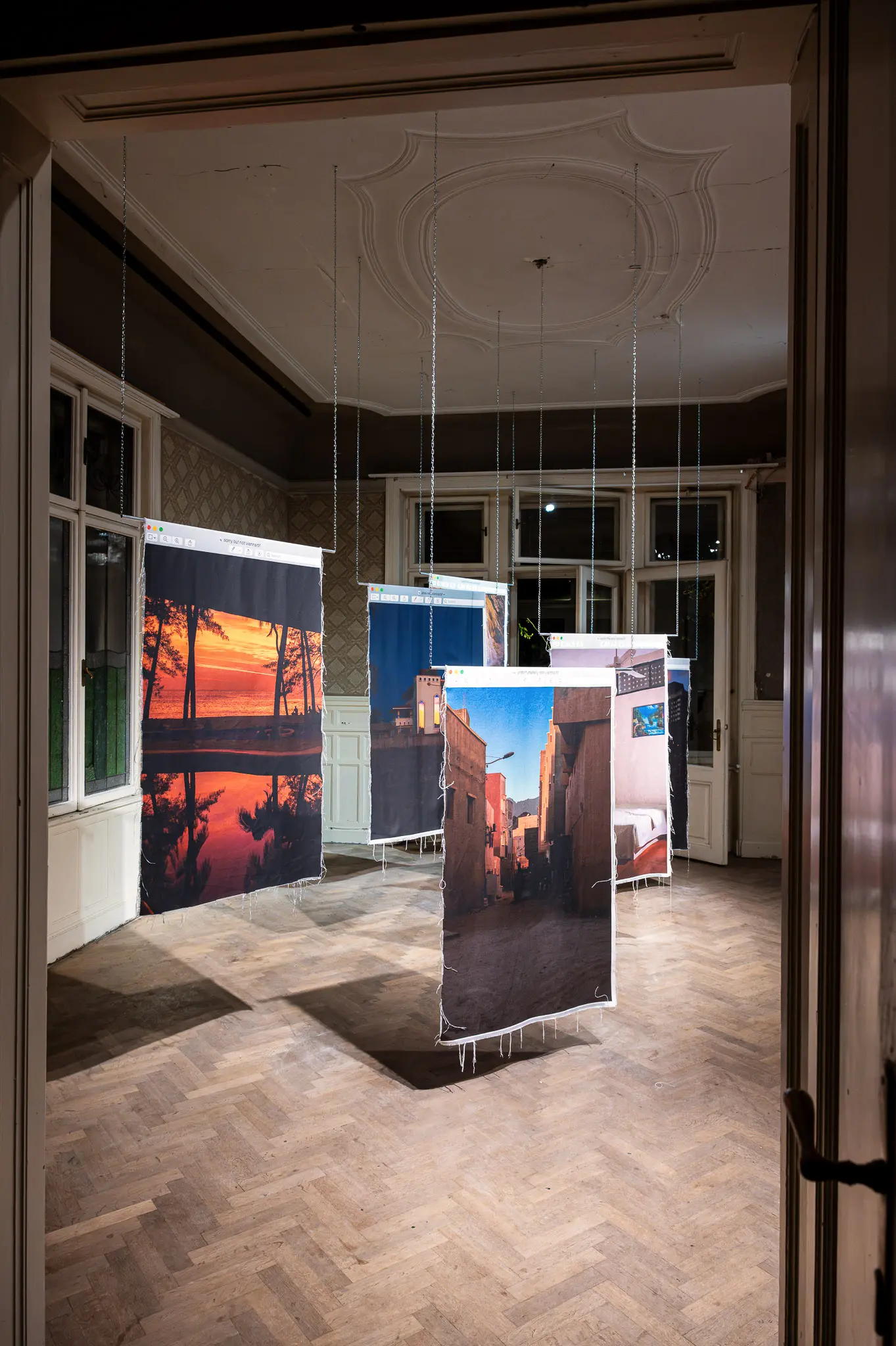 Photographic Exhibition with Suspended Landscape Prints in Interior Gallery Space