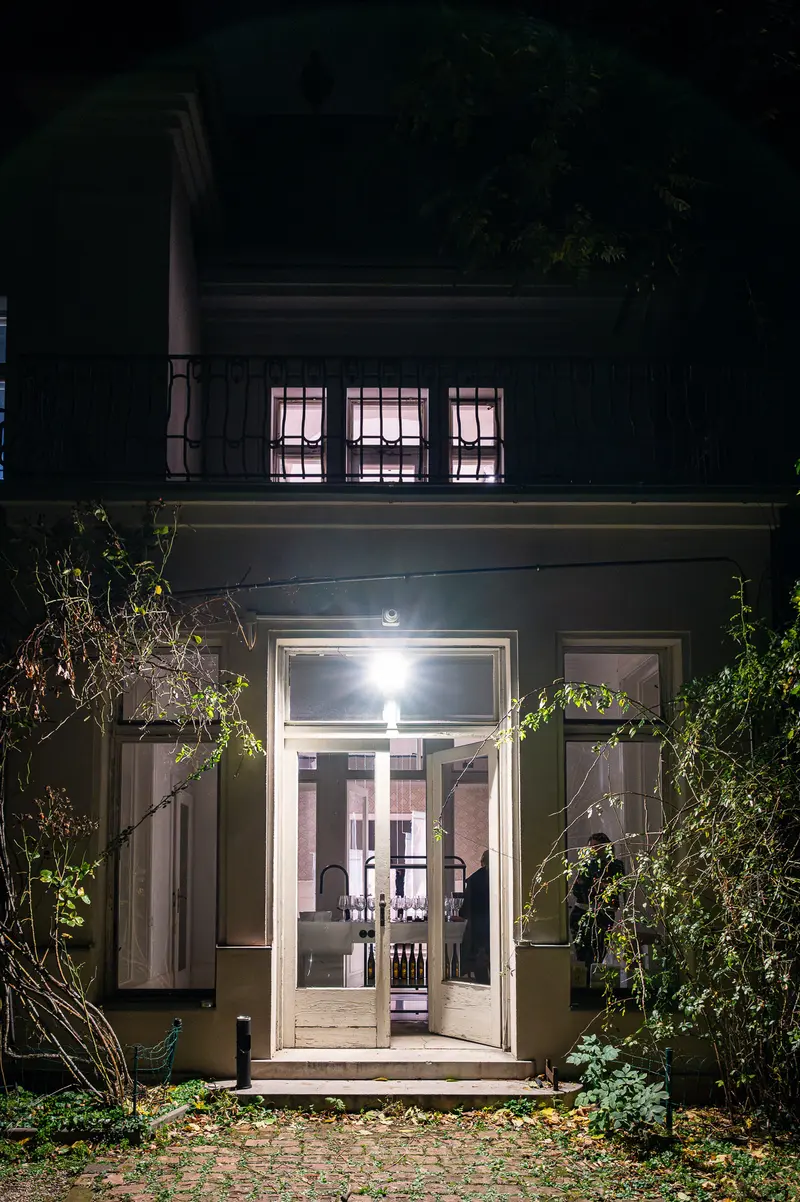 Night Entrance: Illuminated Doorway with Verdant Garden Surroundings
