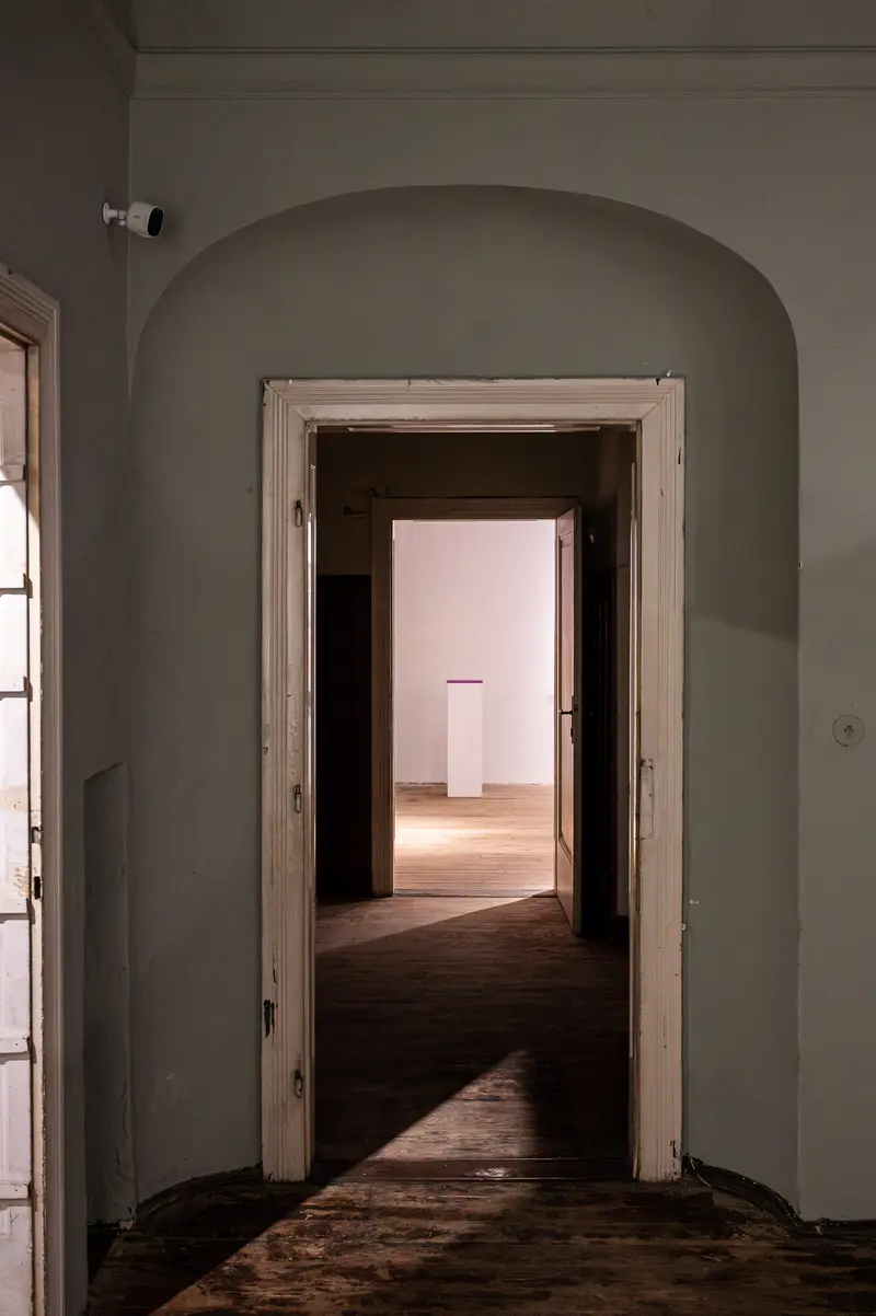 Architectural Interior with Arched Doorway and Oblique Light Passage
