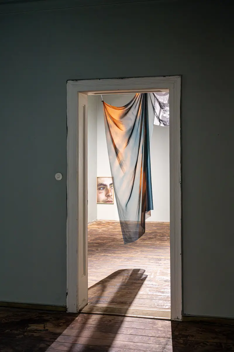 Draped Fabric Casting Shadows Through Doorway in Minimalist Interior
