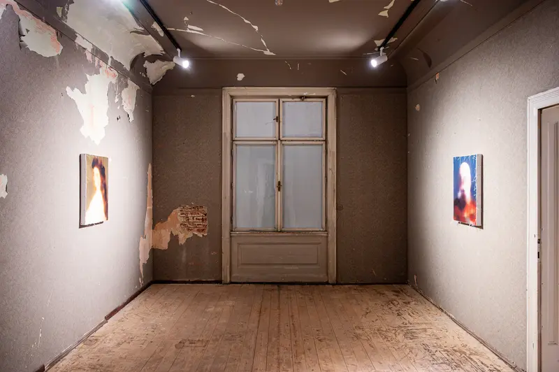 Decaying Gallery Space with Framed Artworks and Peeling Walls
