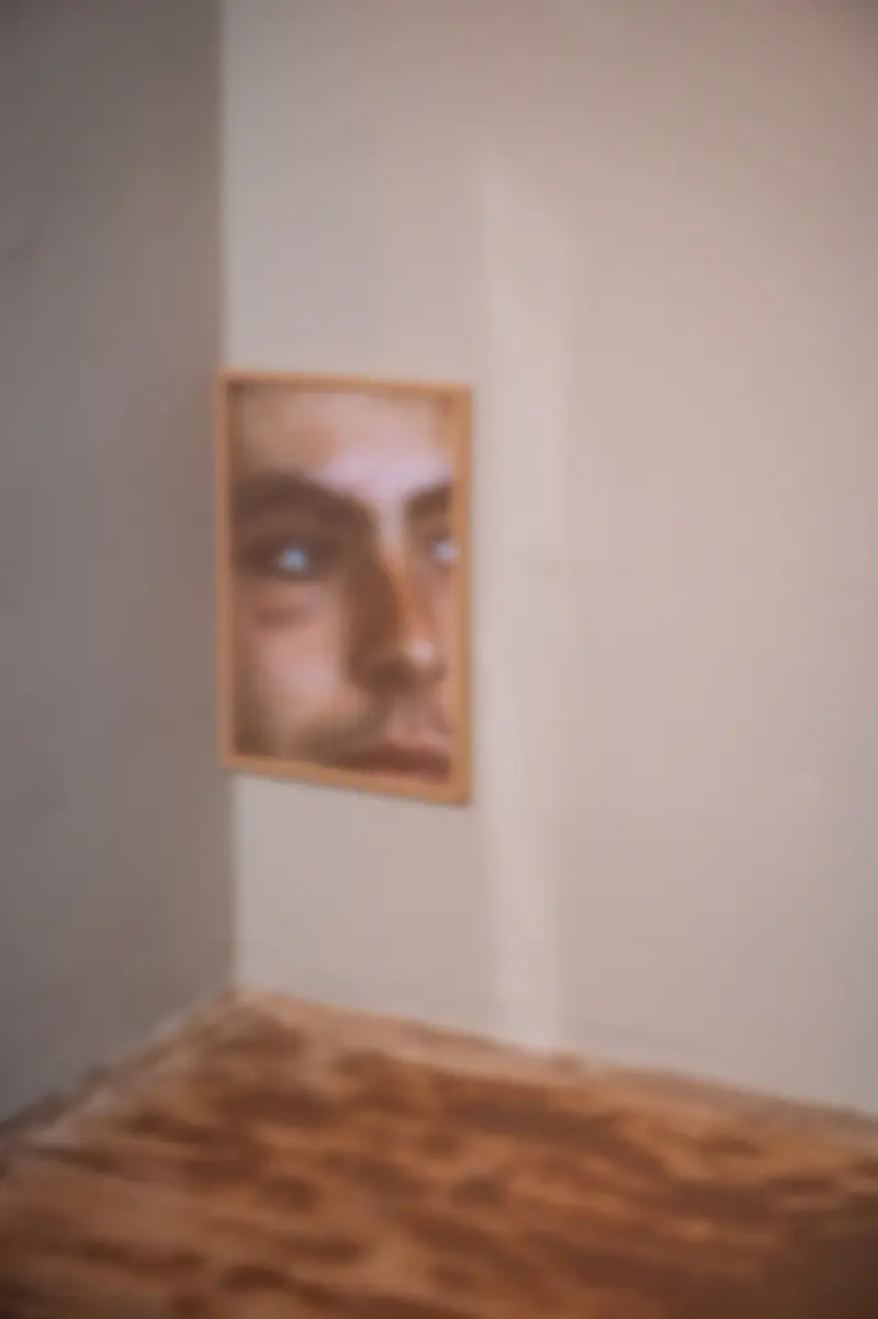 Contemplative Portrait with Blurred Corner and Wooden Surface