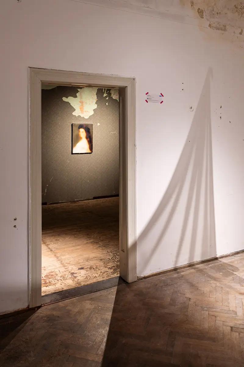 Shadowed Interior with Illuminated Doorway and Abstract Light Projection