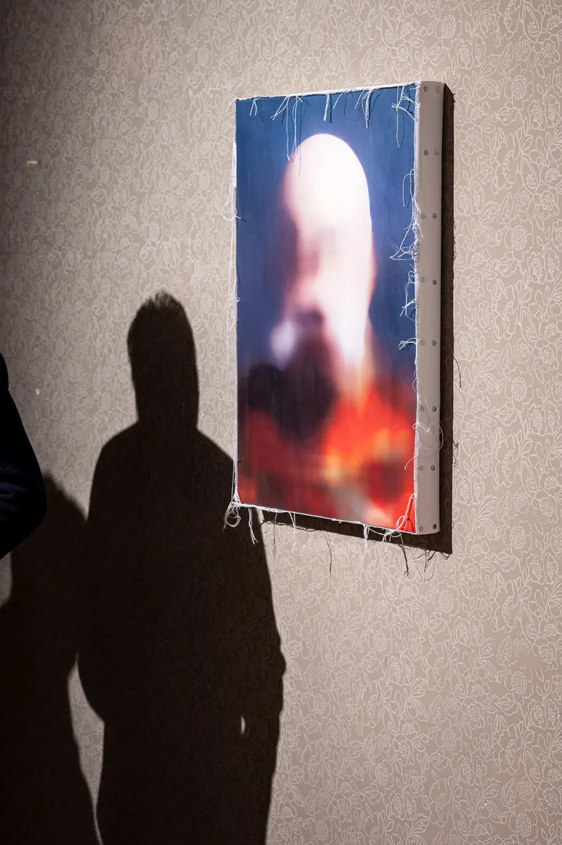 Shadow Silhouette Confronting Blurred Abstracted Portrait on Gallery Wall