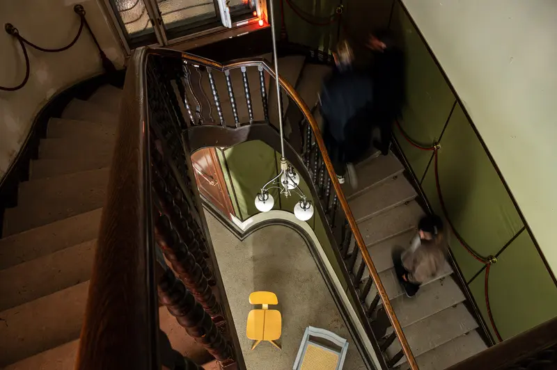 Stairwell Descent with Yellow Chair in Moshammer's Photographic Composition