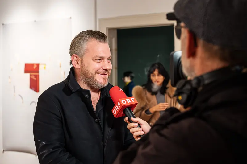 ORF Interview with Media Professional in Black at Exhibition Space