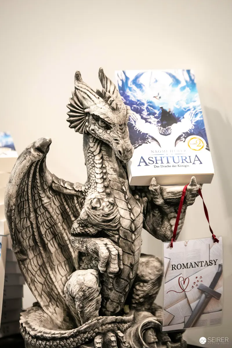 Intricate Dragon Sculpture Displayed with Astiuria Book and Romantasy Tag