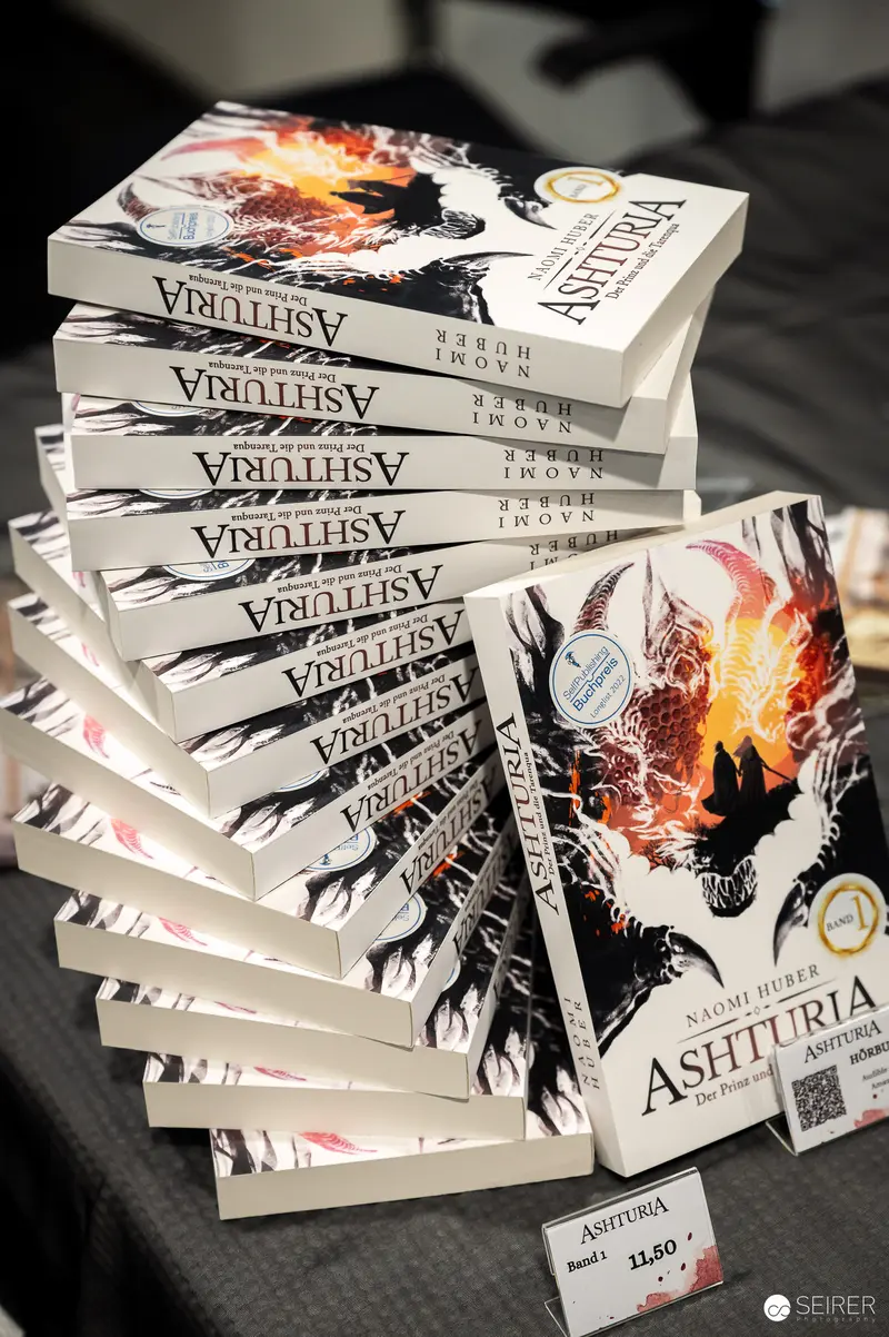 Stacked Copies of Ashturia Book with Dramatic Cover Design