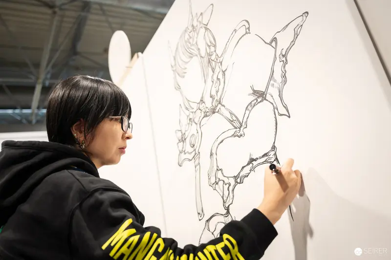 Artist Sketching Intricate Design at Vienna ComicCon 2023 Drawing Workshop