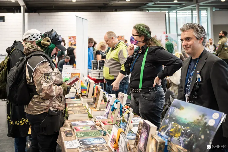 Vienna ComicCon 2023 Cosplay and Comic Book Enthusiasts Browsing Exhibition Tables