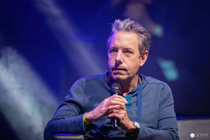 Stand-up Comedian Performing at Vienna ComicCon 2023 with Microphone