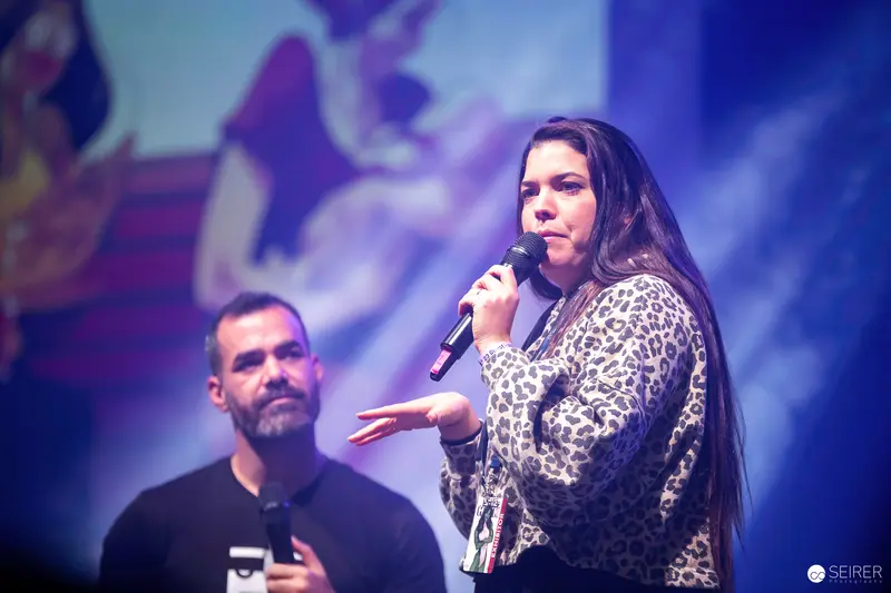 Presenter Duo on Stage at Vienna ComicCon 2023 Discussing Event Highlights