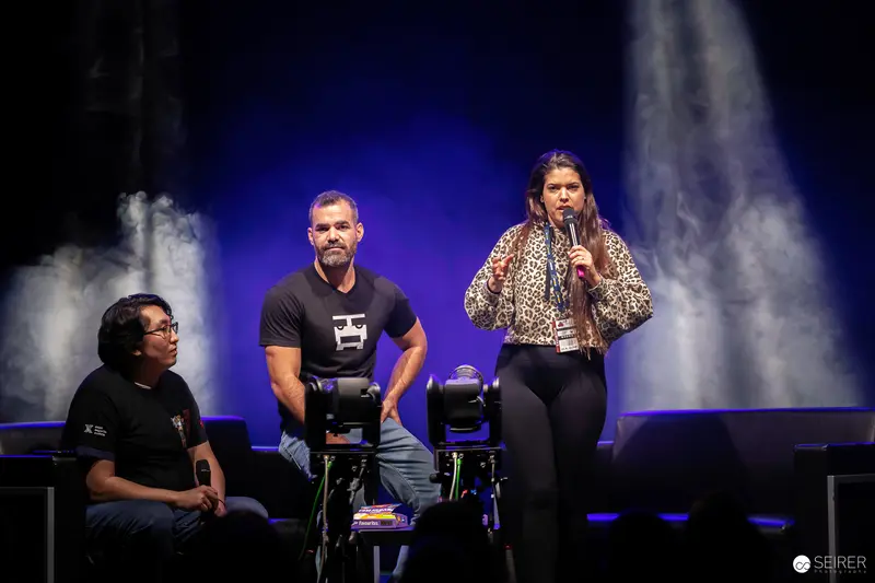 Vienna ComicCon 2023 Stage: Three Presenters in Dramatic Stage Lighting