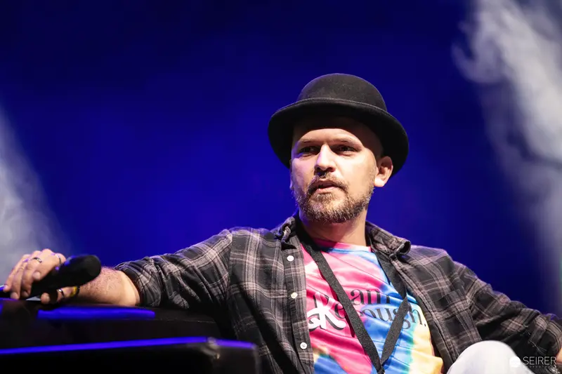 Performer in Plaid Shirt and Hat on Stage at VIECC Comic Convention