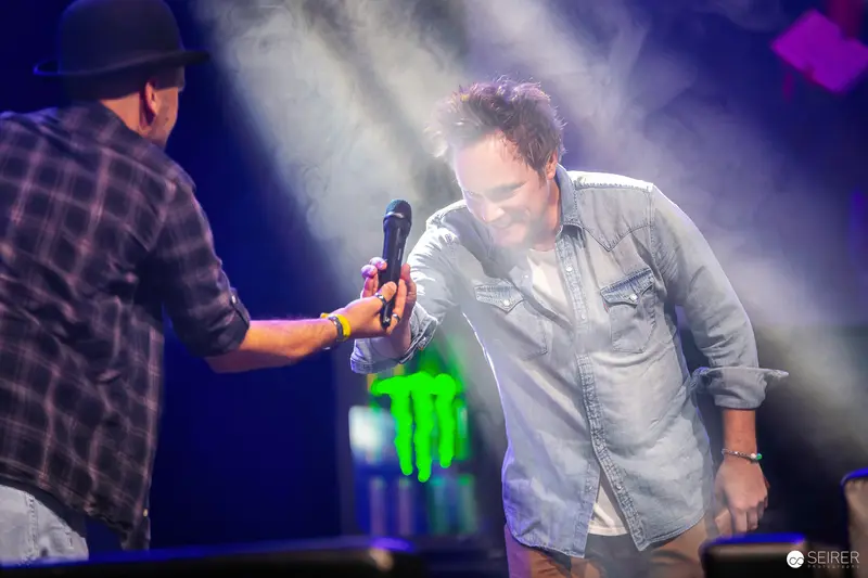 Two Musicians on Stage with Dramatic Lighting at Live Performance Event