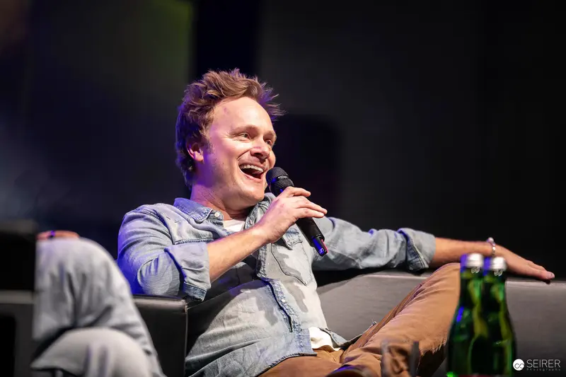Comic Con Speaker Energetically Engaging Audience During Panel Discussion