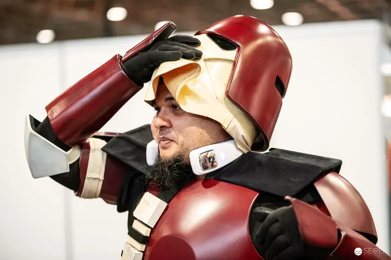Cosplayer in Red and Gold Armored Suit at VIECC Comic Convention