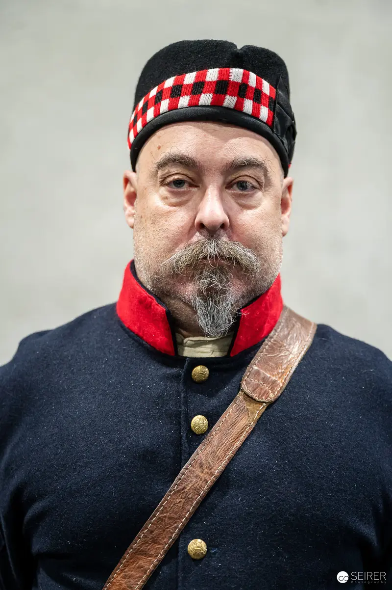 Historical Reenactor in Scottish Military Uniform with Distinctive Headwear