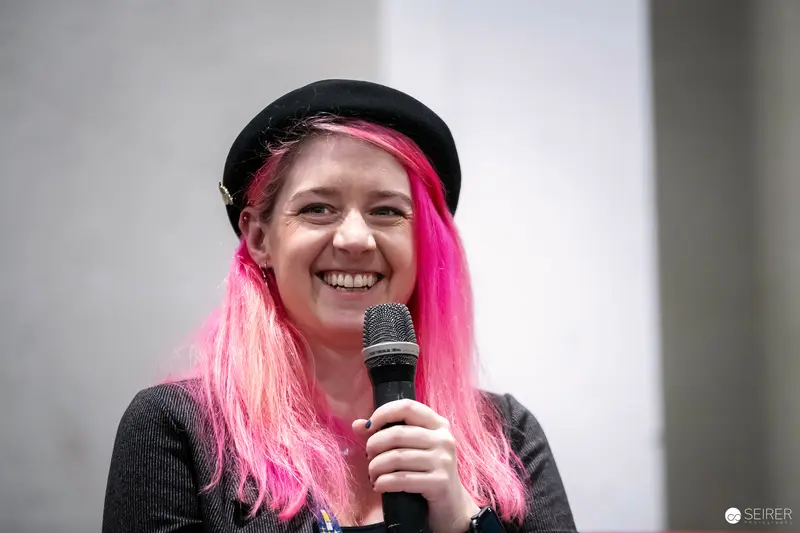Pink-Haired Performer with Microphone at Vienna ComicCon 2023