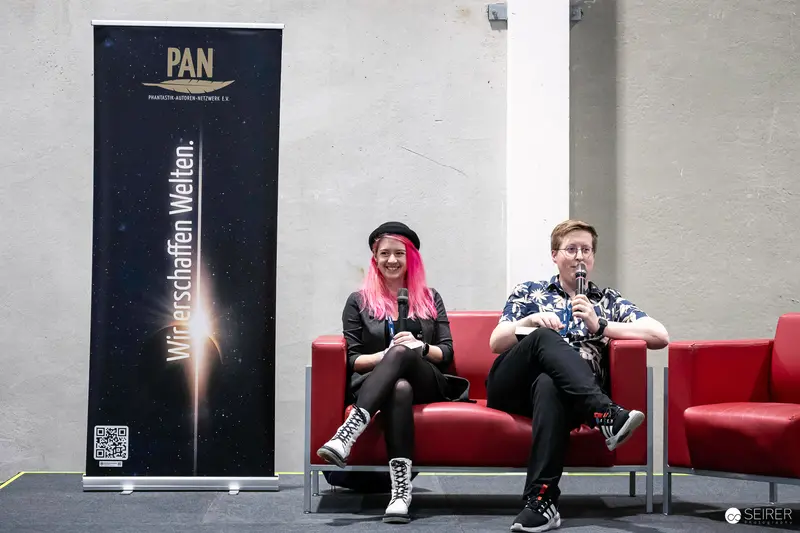 PAN Event Speakers with Pink-Haired Woman at Vienna ComicCon 2023