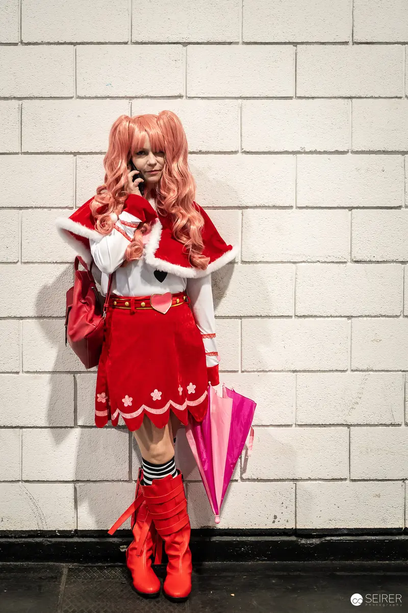 Cosplayer in Vibrant Red Anime-Inspired Costume at Vienna ComicCon 2023