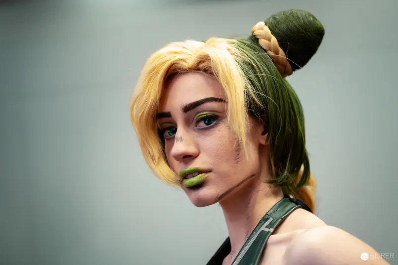 Cosplay Portrait with Green-Blonde Hair Styled in Unique Topknot Arrangement