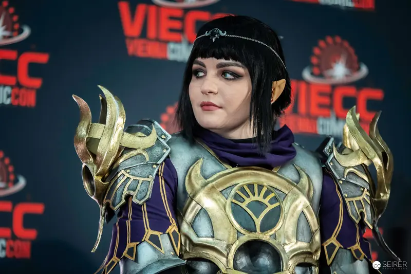 Cosplayer in Ornate Gold and Purple Fantasy Armor at Vienna ComicCon 2023
