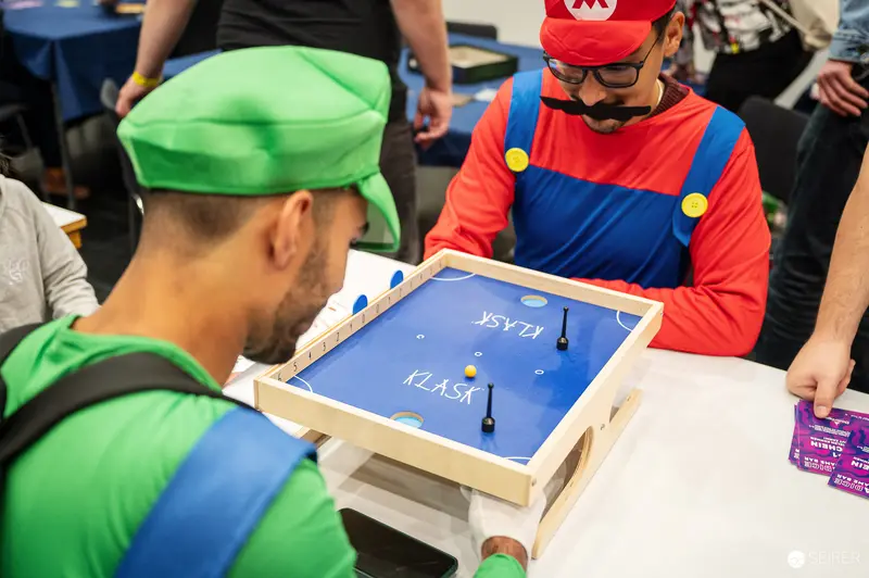 Mario and Luigi Cosplayers Engaging in Tabletop Game at ComicCon