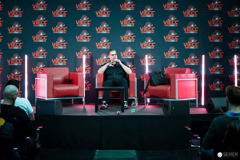 VIECC 2023: Speaker at Press Conference with Red Stage Backdrop