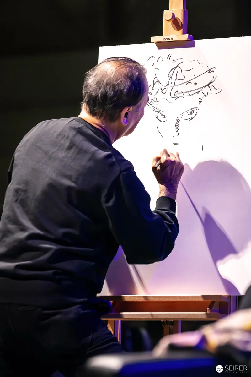 Artist Sketching Intently on Canvas at Drawing Event
