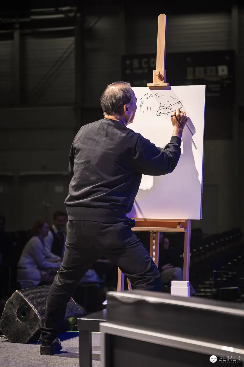 Performance Artist Sketching Dynamically on Stage during Live Drawing Session
