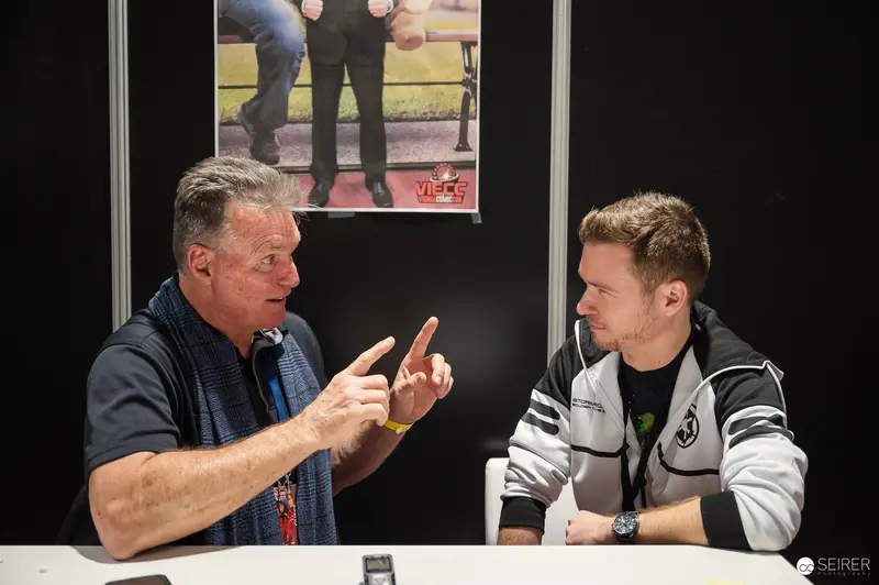 Vienna ComicCon 2023: Intense Discussion Between Two Men at Event Booth
