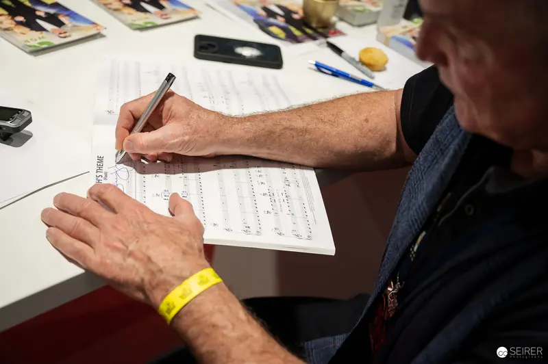 Intense Concentration: Participant Completing Form at Event