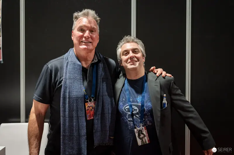 Two Men at Vienna ComicCon 2023 Posing in Convention Hall