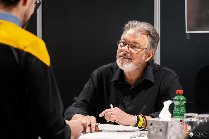 Veteran Comic Artist in Black Shirt at Vienna ComicCon 2023 Signing Table