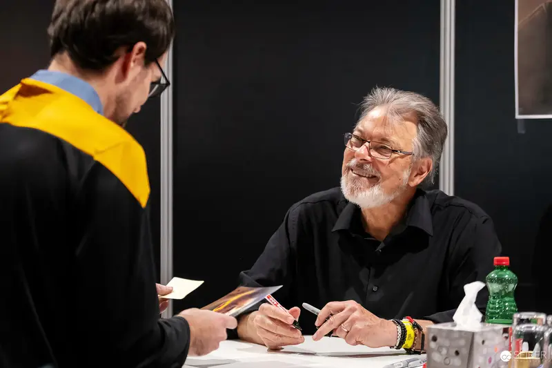 Comic Con Book Signing: Veteran Author with Yellow-Collared Fan